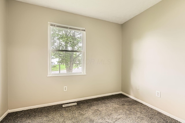 carpeted spare room with baseboards