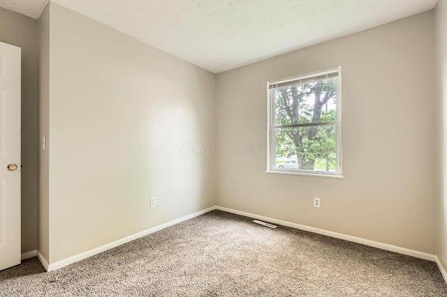empty room with carpet flooring and baseboards