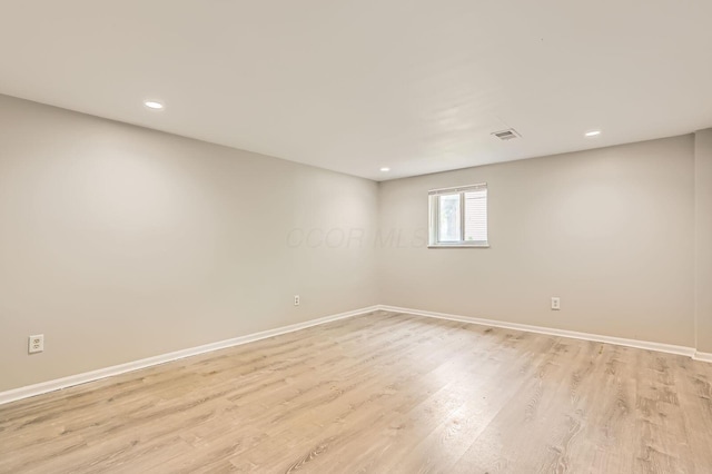 unfurnished room with baseboards, light wood-style floors, and recessed lighting