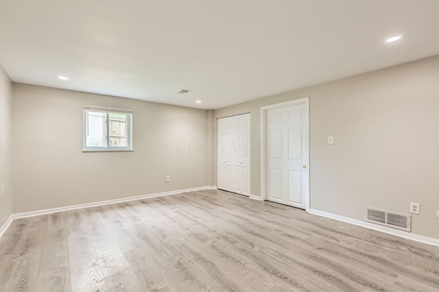 unfurnished bedroom featuring light wood-type flooring, baseboards, and recessed lighting
