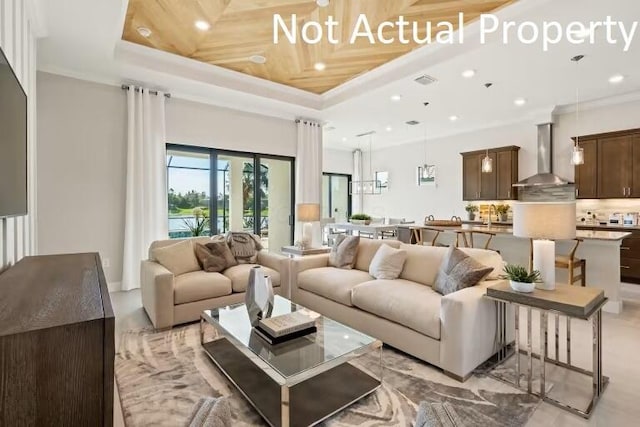 living area featuring ornamental molding, a towering ceiling, visible vents, recessed lighting, and a raised ceiling
