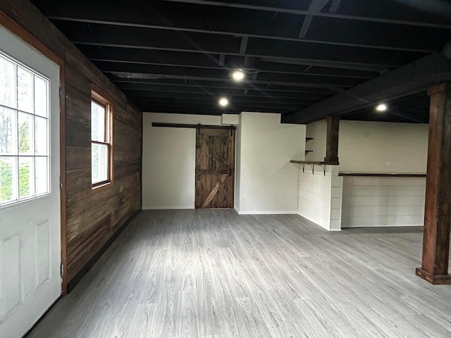 12601 Vincent Rd, Mount Vernon, OH 43050 - basement featuring a barn door, wood walls, and wood finished floors