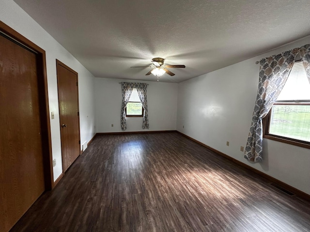 12601 Vincent Rd, Mount Vernon, OH 43050 - unfurnished bedroom with dark wood-type flooring, a textured ceiling, baseboards, and ceiling fan