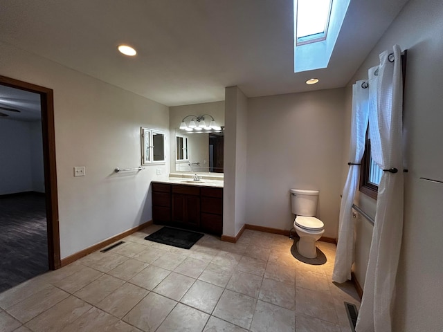 12601 Vincent Rd, Mount Vernon, OH 43050 - bathroom featuring toilet, a skylight, tile patterned flooring, vanity, and baseboards