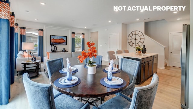 dining space with stairway, light wood-style flooring, and recessed lighting
