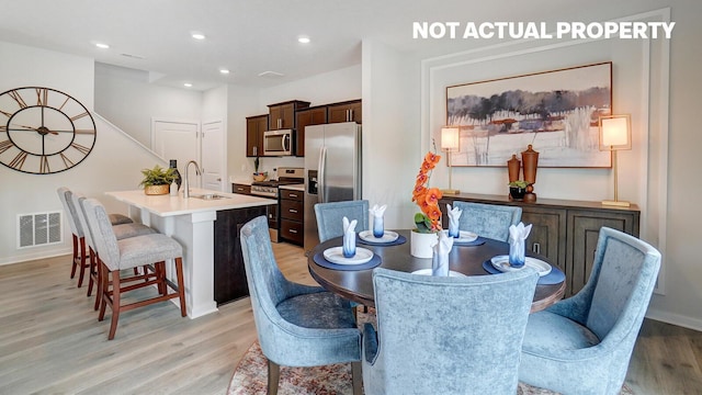 dining area featuring recessed lighting, light wood-style floors, and visible vents