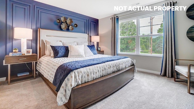 bedroom featuring baseboards and light colored carpet