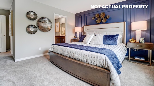 bedroom featuring carpet flooring, ensuite bathroom, and baseboards