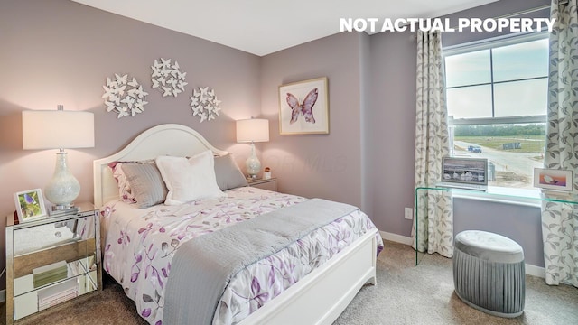 carpeted bedroom featuring baseboards