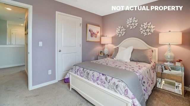 carpeted bedroom featuring baseboards