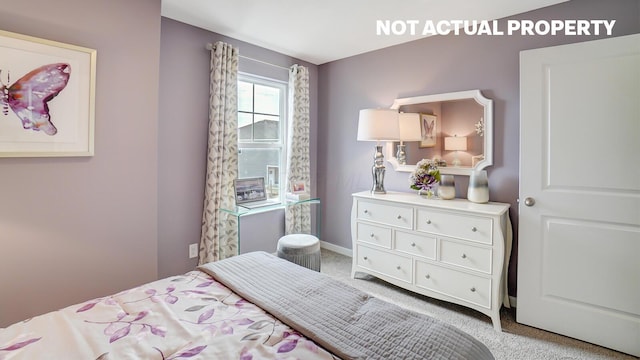 bedroom with light carpet and baseboards