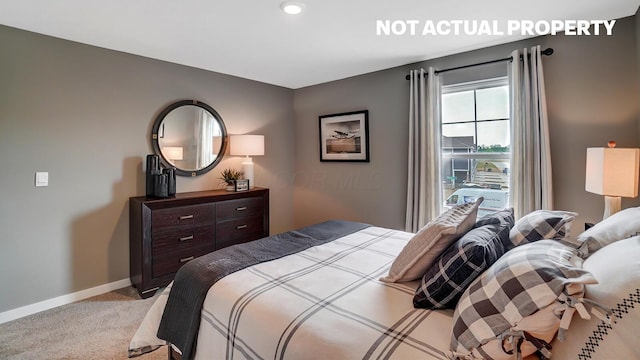 bedroom featuring light carpet and baseboards