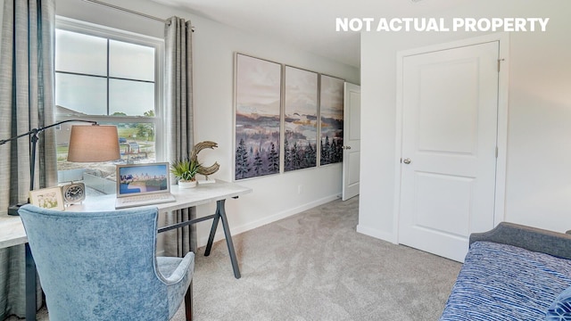 carpeted home office featuring baseboards