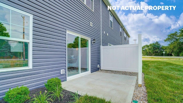 view of side of home with a yard