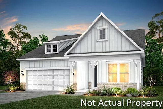 modern farmhouse with roof with shingles, stone siding, driveway, a garage, and board and batten siding