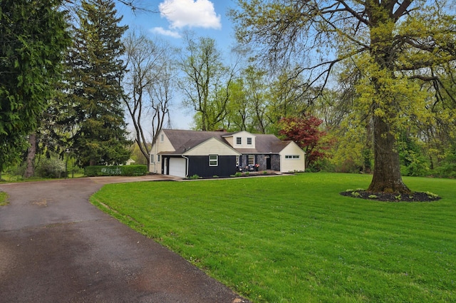 1899 S Main St, Mansfield, OH 44904 - view of front facade featuring a front lawn, board and batten siding, aphalt driveway, and a garage