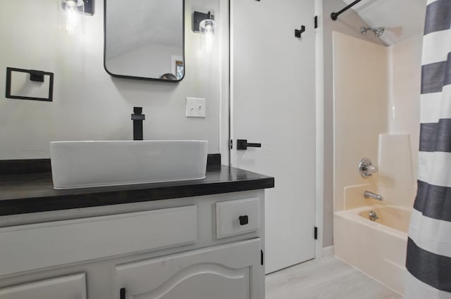 1899 S Main St, Mansfield, OH 44904 - full bath featuring wood finished floors, shower / tub combo, baseboards, and vanity
