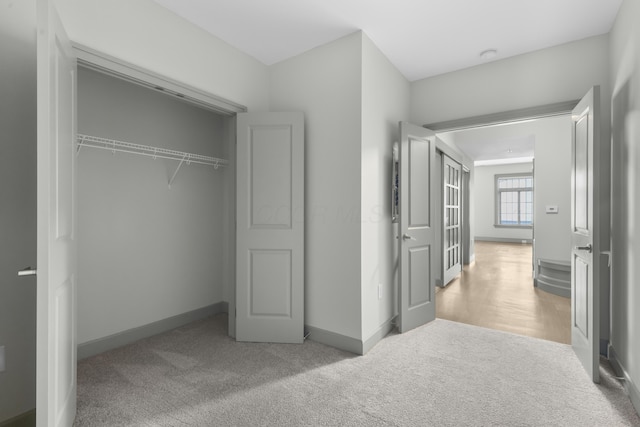 51 N High St Unit 408, Columbus, OH 43215 - unfurnished bedroom featuring carpet, baseboards, and a closet