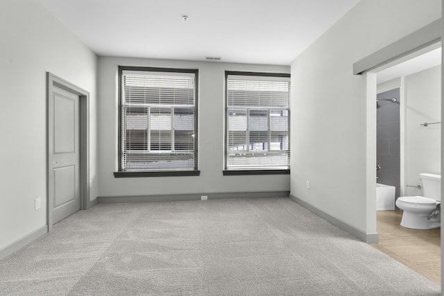 51 N High St Unit 408, Columbus, OH 43215 - unfurnished bedroom with carpet, baseboards, and ensuite bath