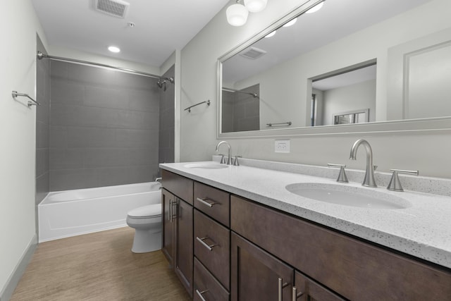 51 N High St Unit 408, Columbus, OH 43215 - full bathroom featuring wood finished floors, toilet, double vanity, and shower / washtub combination