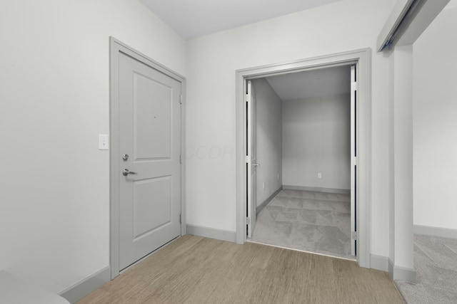 51 N High St Unit 408, Columbus, OH 43215 - hall featuring baseboards, light wood-type flooring, and light colored carpet