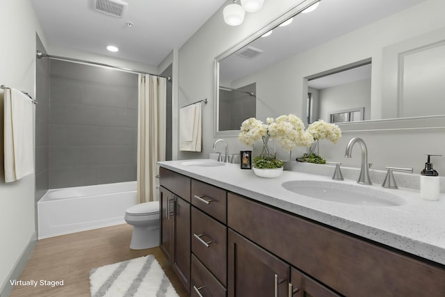 51 N High St Unit 408, Columbus, OH 43215 - bathroom with wood finished floors, shower / bath combo, double vanity, and toilet