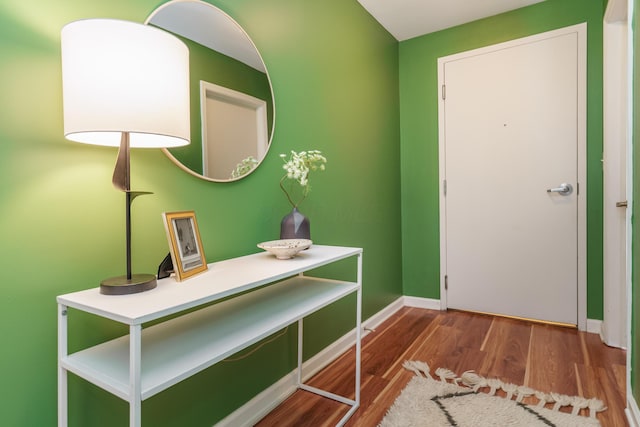interior space with baseboards and wood finished floors