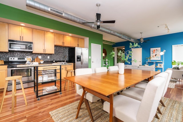 dining room with track lighting, visible vents, light wood-style flooring, and ceiling fan
