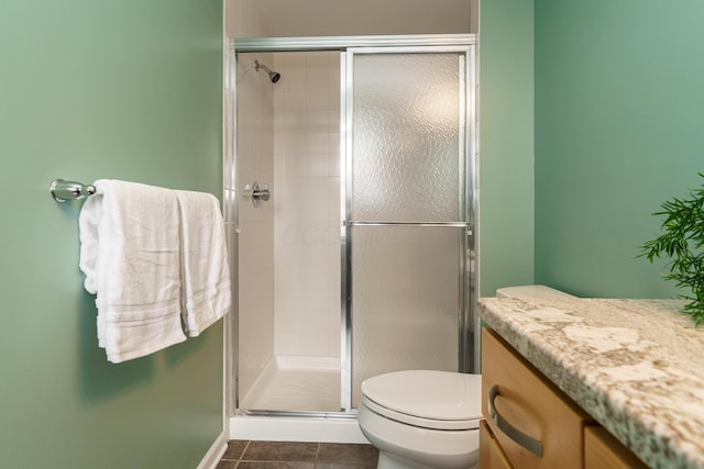 full bathroom with tile patterned floors, toilet, and a shower stall