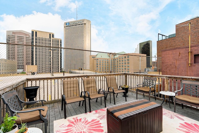 wooden terrace featuring a view of city
