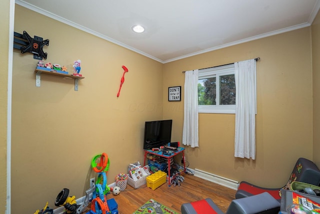 26 Garrick St, Newark, OH 43055 - recreation room with wood finished floors, ornamental molding, baseboards, and a baseboard heating unit