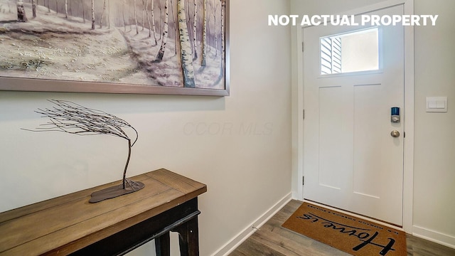foyer featuring dark wood-style flooring and baseboards