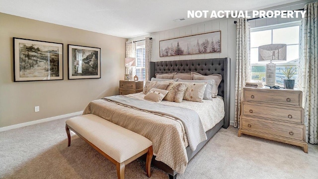 bedroom featuring light colored carpet, baseboards, and visible vents