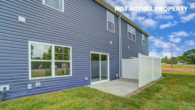 back of property with a lawn