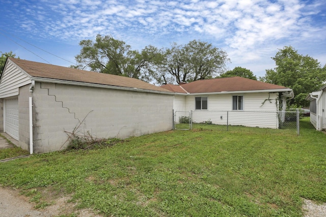 135 Fernhill Ave, Columbus, OH 43228 - rear view of house featuring concrete block siding, a detached garage, and a shingled roof