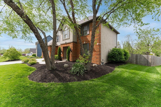 view of side of property featuring stucco siding and brick siding