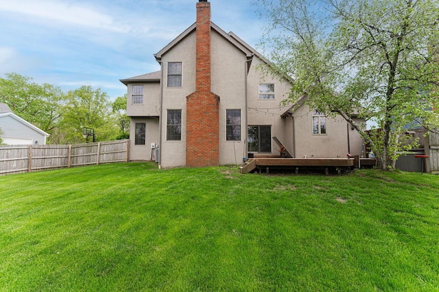 rear view of property with stucco siding and a chimney
