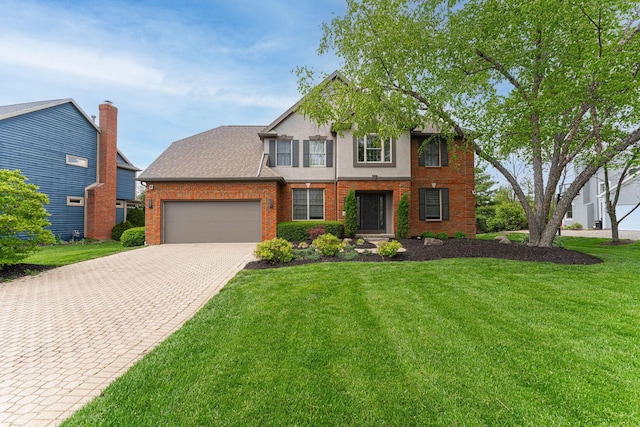 traditional home with an attached garage, brick siding, driveway, and a front yard
