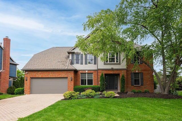 382 Beecher Rd, Columbus, OH 43230 - view of front of property with a garage, decorative driveway, a front lawn, brick siding, and stucco siding