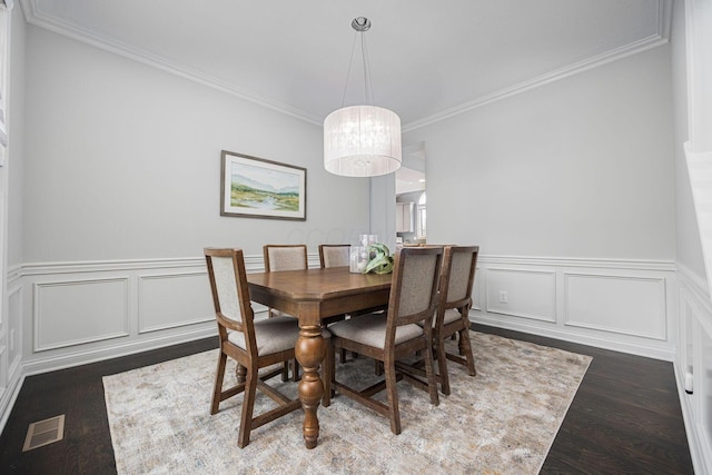 382 Beecher Rd, Columbus, OH 43230 - dining space with wood finished floors, crown molding, a wainscoted wall, and a decorative wall