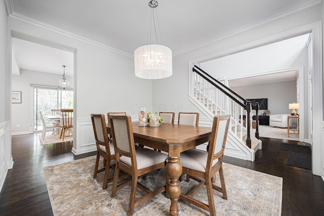382 Beecher Rd, Columbus, OH 43230 - dining area with stairs, dark wood-style flooring, a chandelier, crown molding, and wainscoting
