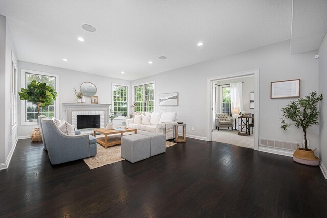 382 Beecher Rd, Columbus, OH 43230 - living room featuring wood finished floors, baseboards, recessed lighting, and a brick fireplace