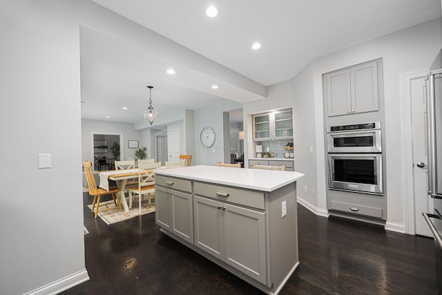 382 Beecher Rd, Columbus, OH 43230 - kitchen with gray cabinetry, stainless steel double oven, recessed lighting, dark wood-type flooring, and light countertops