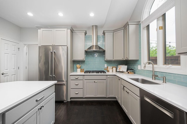 382 Beecher Rd, Columbus, OH 43230 - kitchen with stainless steel appliances, wall chimney exhaust hood, a sink, light countertops, and dark wood-type flooring