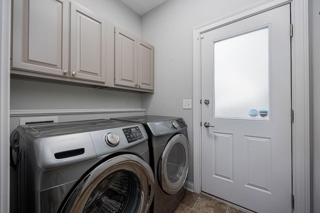 382 Beecher Rd, Columbus, OH 43230 - washroom featuring washer and clothes dryer, cabinet space, and dark stone finish floors