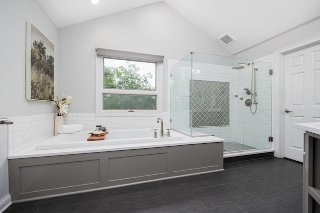 382 Beecher Rd, Columbus, OH 43230 - bathroom featuring lofted ceiling, a garden tub, a shower stall, tile patterned flooring, and vanity