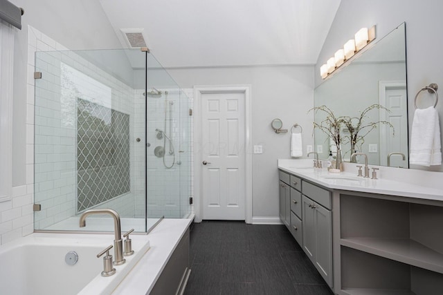 382 Beecher Rd, Columbus, OH 43230 - bathroom with a garden tub, double vanity, a stall shower, baseboards, and vaulted ceiling