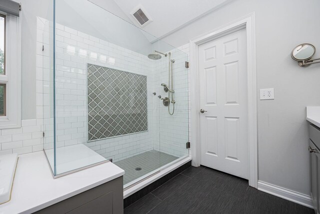 382 Beecher Rd, Columbus, OH 43230 - bathroom with vanity, a shower stall, vaulted ceiling, and tile patterned floors