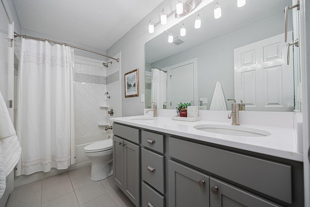 382 Beecher Rd, Columbus, OH 43230 - bathroom with double vanity, shower / bath combination with curtain, tile patterned floors, and toilet