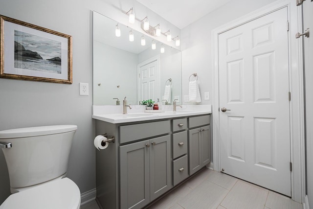 382 Beecher Rd, Columbus, OH 43230 - full bathroom with double vanity, toilet, and tile patterned floors